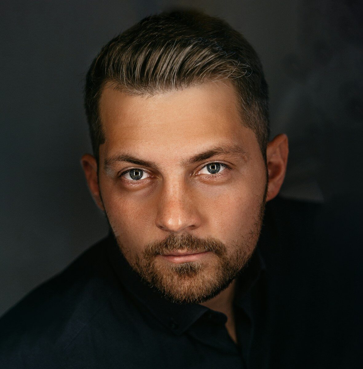 a man with a beard and a black shirt